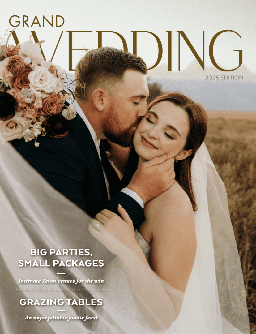 Bride and groom embracing in field